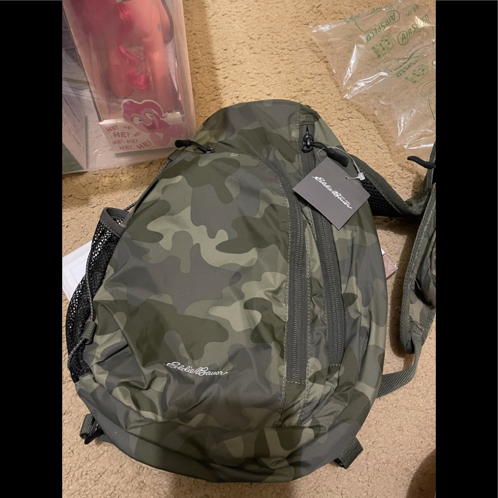 Eddie Bauer sling bag. Camo green. Nylon with pockets and adjustable strap. New.